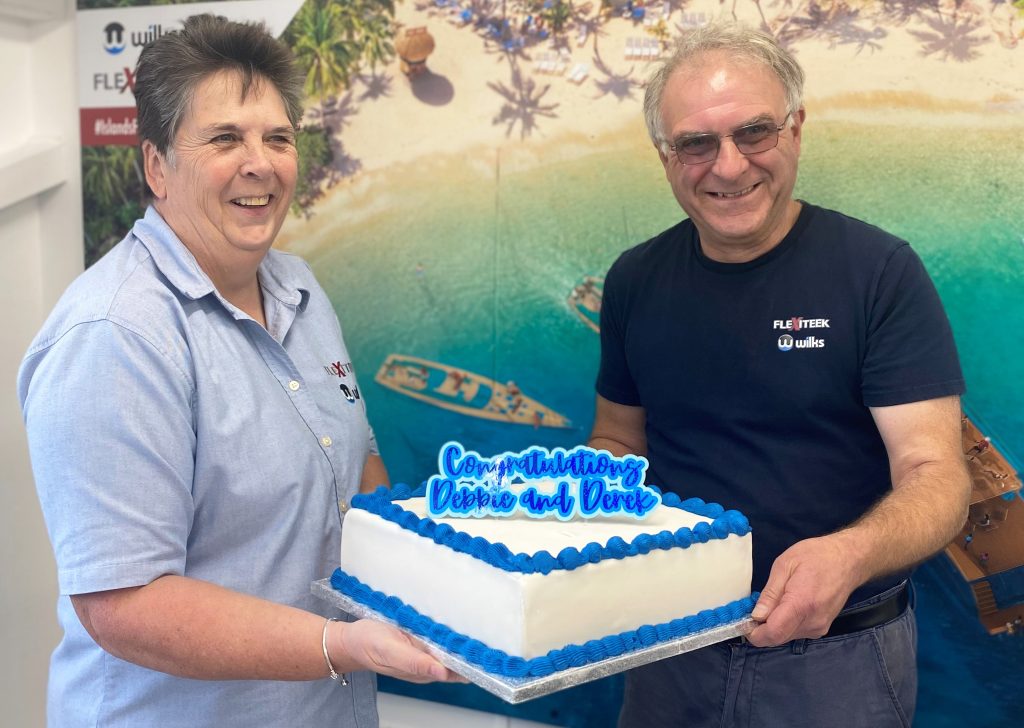 Debbie Hutton and Derek Shakespeare with a long service celebration cake.